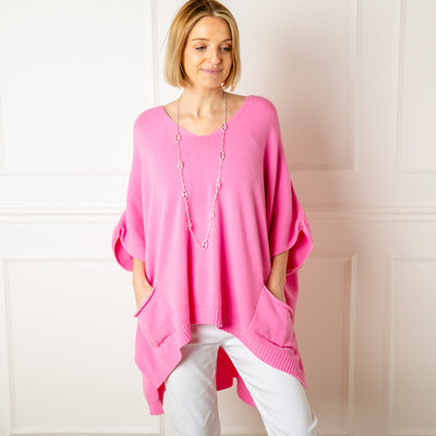 The pink V Neck Pocket Poncho in a relaxed silhouette made from a fine knitted material